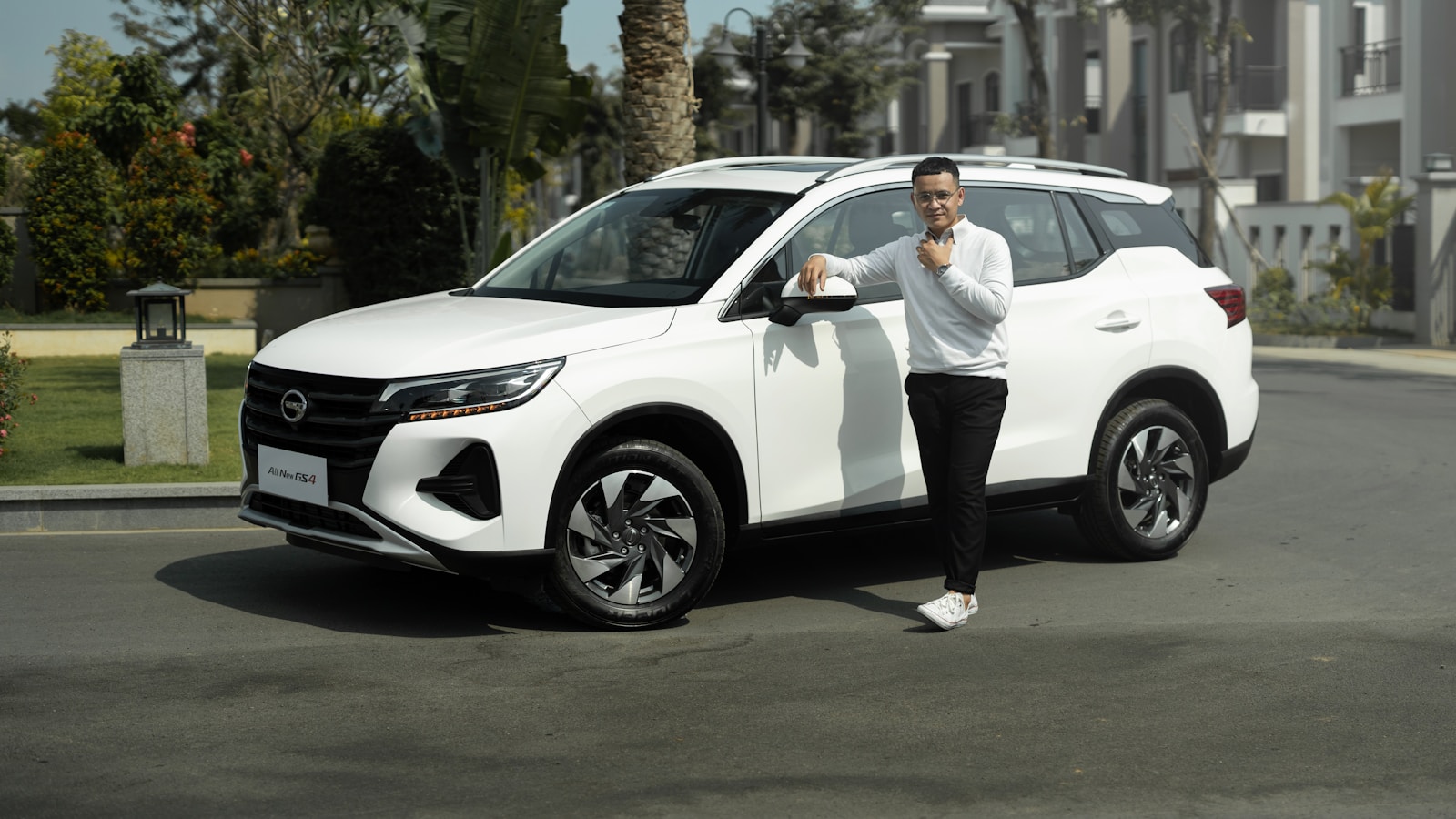 a man standing next to a white suv